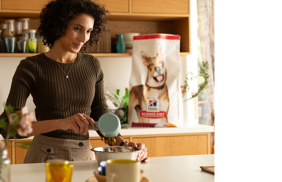A woman serving hill's food on a bowl